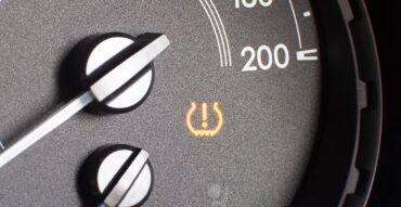 Tyre pressure sensor warning light on car dashboard