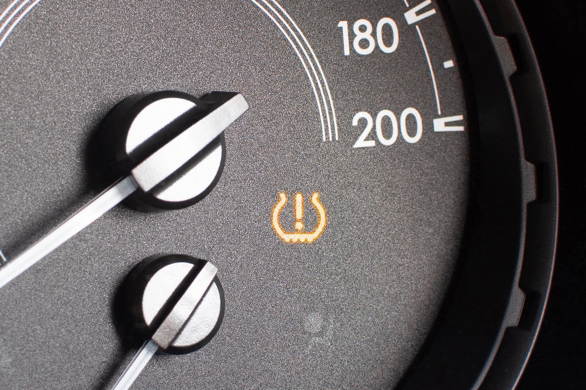 Tyre pressure sensor warning light on car dashboard